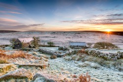 A beautiful frosty winter sunrise over an old abandoned farm at Garrow Tor on Bodmin Moor in Cornwall
