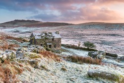 Beautiful dramatic sunset over an old abandoned granite stone cottage on the foothills of Brown Willy on Bodmin moor, the highest point in Cornwall