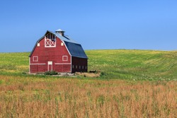 Red Barn on Green Field with Blue Sky