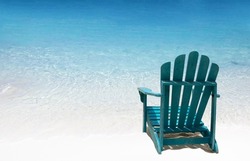 Single wooden chair on white sand beach. Solo travellng concept.