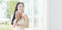Young asian woman holding bouquet. Beauty concept. Skin care. Body care. 