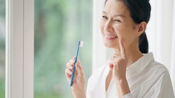 Senior Asian woman brushing her teeth. Dental care. Oral care.