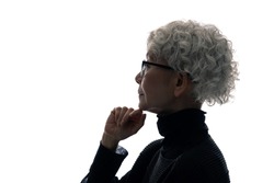 Silhouette of thinking elderly Asian woman.