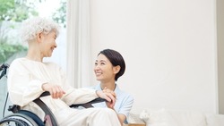 Asian elderly woman and caregiver. nursing care concept.