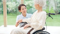 Asian elderly woman and caregiver. nursing care concept.