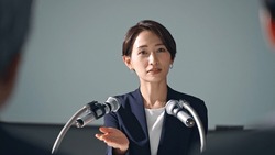 Asian woman giving a press conference