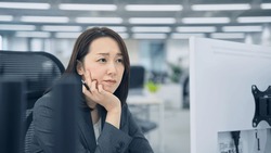 Asian woman worrying in office.