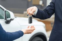 Man handing car smart key. Car rental. Car sharing.