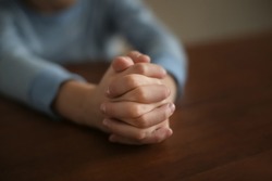 Little boy praying at table, closeup