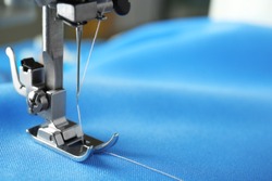 Sewing machine with fabric and thread, closeup