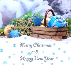 Composition with Christmas decorations in basket on winter background as greeting card