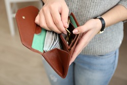 Girl with brown wallet full of money