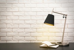 Modern lamp on the desk on white wall background
