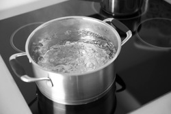 Boiling spaghetti in pan on electric stove in the kitchen