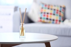 Handmade reed freshener on white table in living room, close up