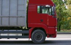 Side view of red American cargo truck