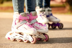 Children on roller skates in park, closeup