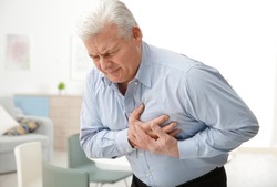 Man with chest pain suffering from heart attack in office
