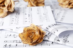 Paper rose on music notes