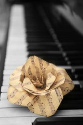 Rose made of music notes on piano keys