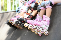 Legs of children on rollers at skate park