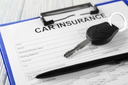 Car insurance form and key on table
