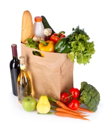 vegetables and wine in a paper bag isolated on white