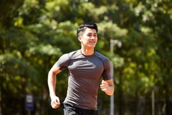 young asian adult man athlete running and training.