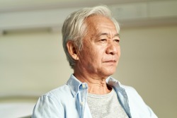 portrait of asian old man with serious facial expression