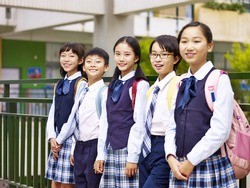 portrait of a group of asian elementary school children looking at camera smiling