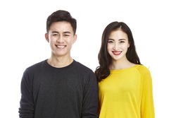 studio portrait of a young asian couple happy and smiling looking at camera, isolated on white background.