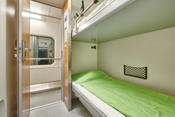 Train berth corridor indoor with two beds. Travel background. Horizontal