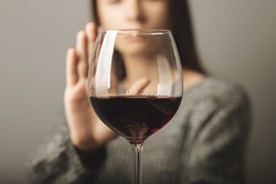 reject liquor,stop alcohol, teenager girl shows a sign of refusal of wine