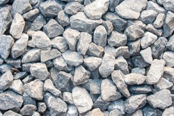 Gravel texture. Pebble stone background. Light grey closeup small rocks. Top view of ground gravel road.