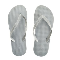 Grey rubber flip-flops isolated over white background, pair shot above