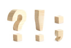 Four wooden punctuation marks isolated over the white background, question and exclamation marks, dot and comma