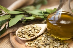 Pumpkin seed oil in a glass bottle with seeds