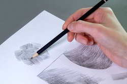 The artist draws  with pencils on paper. Art Studio.  Ideas of creativity.