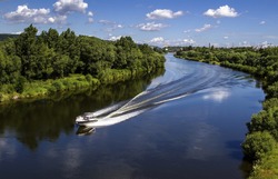 Landscape of banks of the river, speed boat on the river, summer day.View from above.