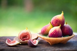Ripe sweet figs. Healthy mediterranean fig fruit and slice figs on rustic wooden background