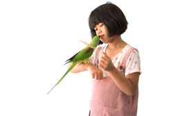 Portrait of a kid girl with her domestic parrot over white background