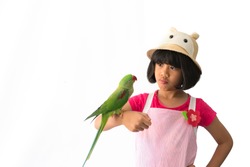 Portrait of a kid girl with her domestic parrot over white background
