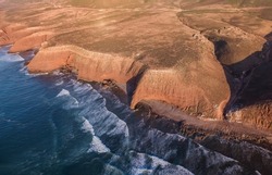 Aerial view on Legzira beach with arched rocks on the Atlantic coast at sunset in Morocco