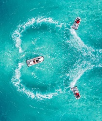Jet Ski water sport lifestyle. Water splash love heart shape. Romantic couple trip on Valentine's Day. Aerial view clear turquoise sea. Maldives tropical island summer vacation.