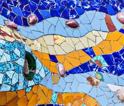 texture mosaic of colored ceramic tile by Antoni Gaudi at his Parc Guell, Barcelona, Spain