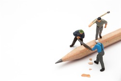 Small people with handsaw cutting the pencil 