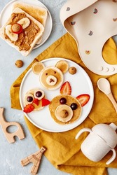 Animal Shaped Pancake with strawberry and fruit for kids. Plate with funny pancake. Funny breakfast idea for children. Kids meal. Flat Lay