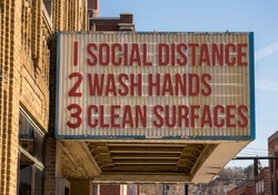 In this photo illustration of a movie cinema billboard with three basic rules to avoid the coronavirus or Covid-19 epidemic of wash hands, maintain social distance and clean surfaces