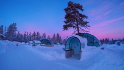 Sunrise above amazing glass igloo village at Kakslauttanen Arctic Resort Finland
