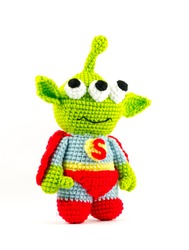handmade crochet green alien three eyes super hero doll on white background, turn right side